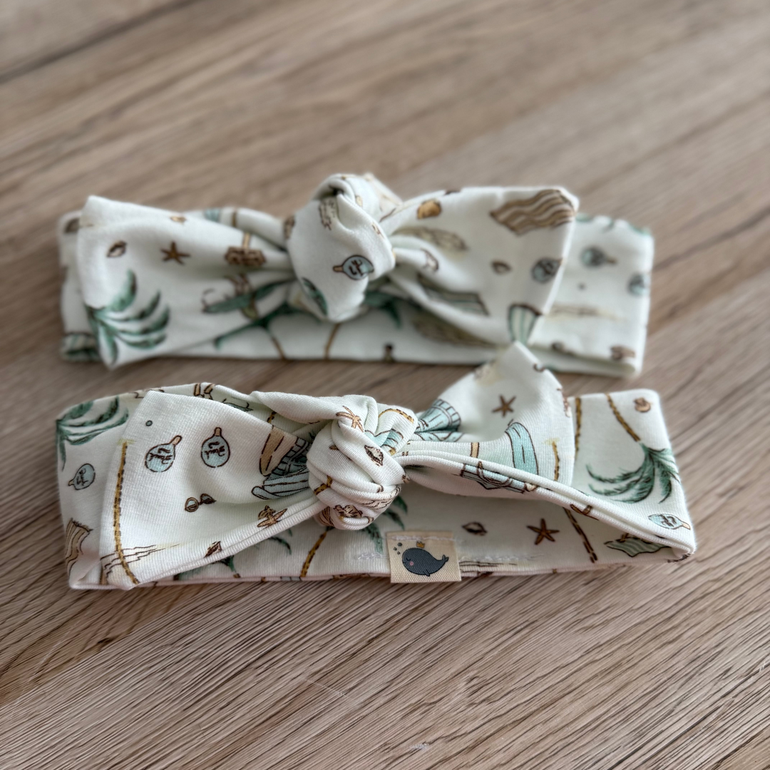 Two patterned headbands on a wooden surface
