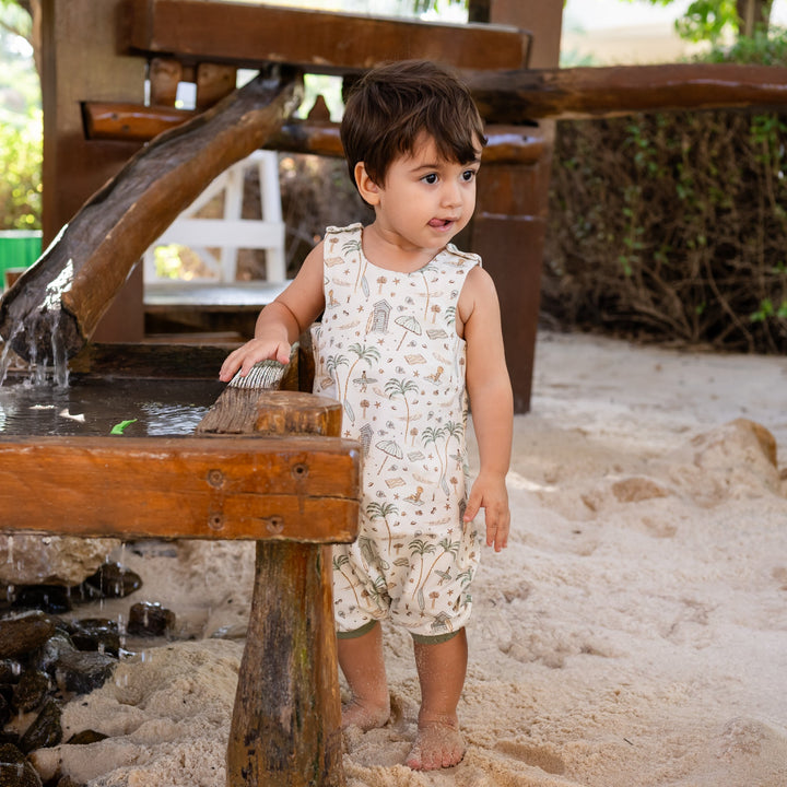 Child playing near a water fountain in an outdoor setting