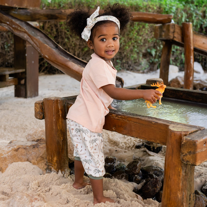 Child playing with water at a sand and water play area.
